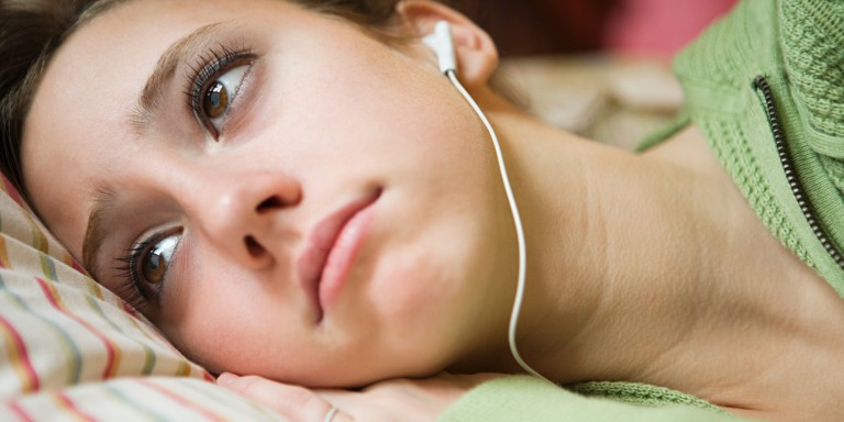 A teenage girl listening to music